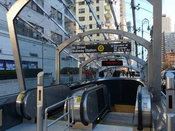 A subway station entrance with a sign that reads "Elevator at 96 Street Subway Station".