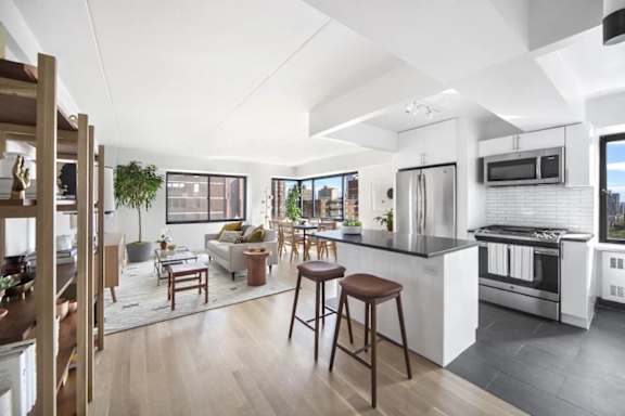 A modern kitchen with a bar stool and a countertop.