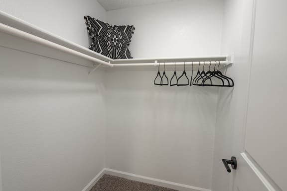 a walk in closet with a white rail and a black and white pillow&#xA0;at THE ARLO, Citrus Heights
