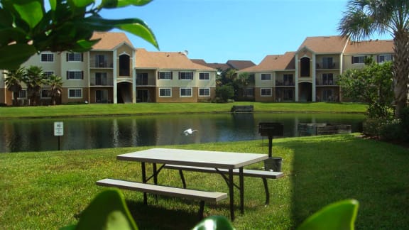 San Marco community exterior with lake and picnic area at San Marco Apartments, Florida 32174