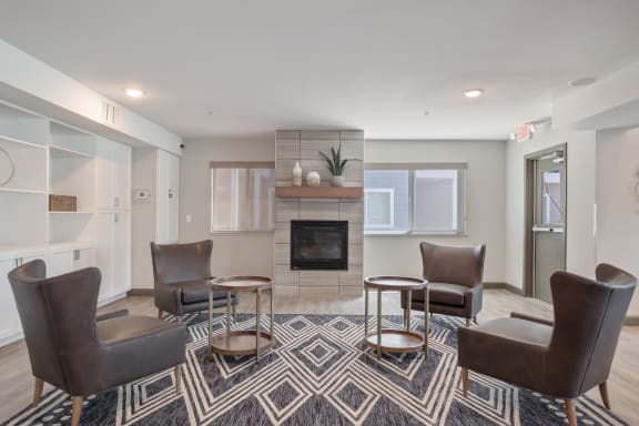 Over 55 Communities in Reno, NV - Vintage at Citi Vista - Lobby Area with Fireplace, Lounge Seating, and Small Round Tables
