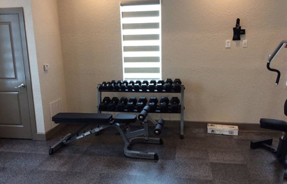fitness center with free weights at The Edge at Town Center Apartments, Jacksonville