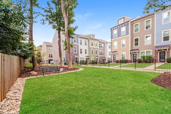 A grassy area in front of apartment buildings.