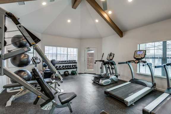 A well-equipped home gym with a variety of exercise equipment.