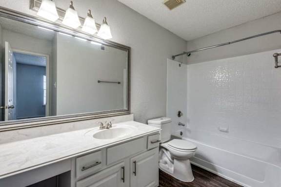 A white bathroom with a sink, toilet, and bathtub.