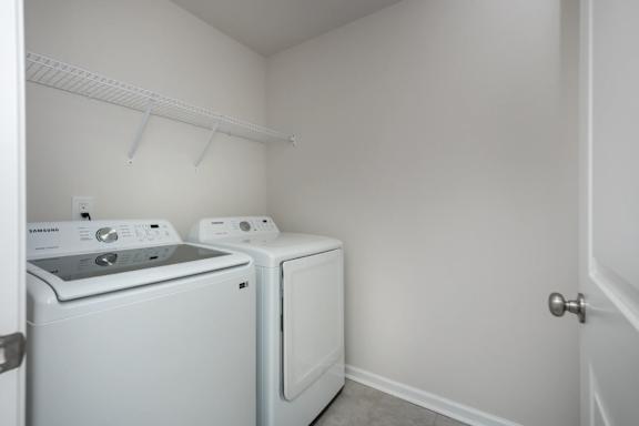 A small laundry room with a washer and dryer.