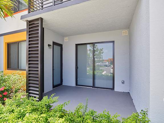 A modern house with a balcony and a garden.