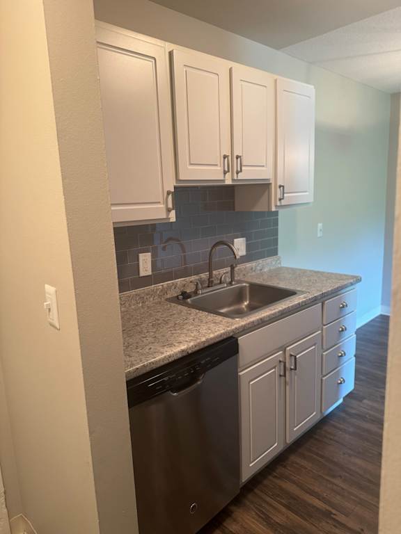 A kitchen with a sink and cabinets.