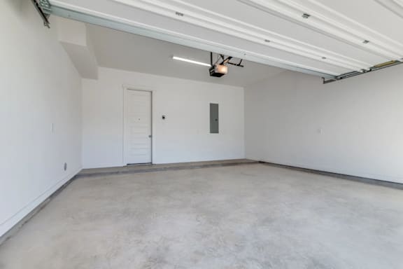 A large empty room with a door and a window.