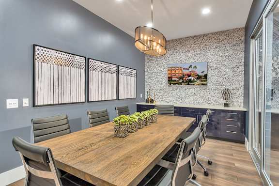A conference room with a long table and chairs.