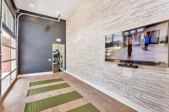 A yoga studio with a large mirror on the wall.