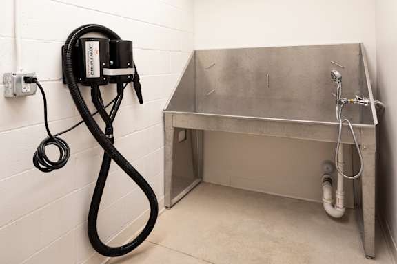 A vacuum cleaner is plugged into an outlet on a wall.