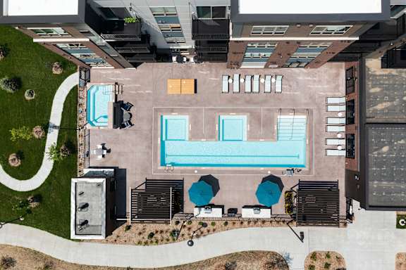 An aerial view of a swimming pool surrounded by a concrete wall.