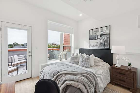 A bedroom with a large bed and a view of the outside.