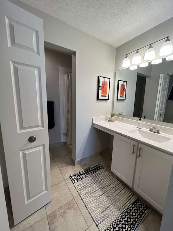 A bathroom with a white door, sink, and mirror.