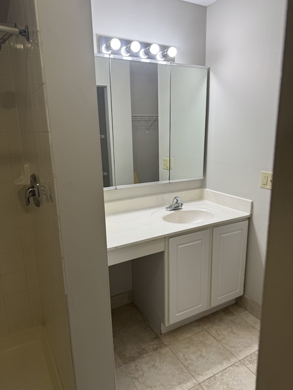 A white bathroom with a sink and mirror.