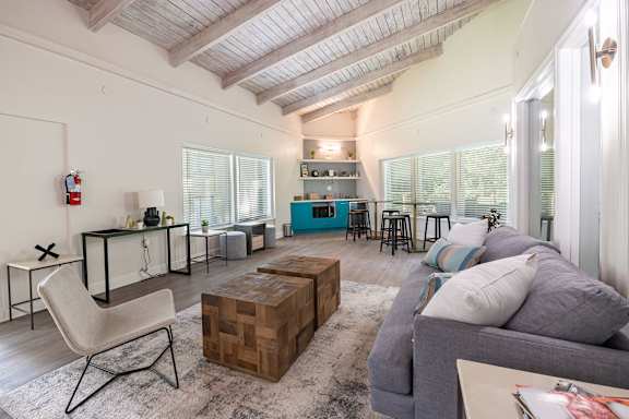 A living room with a grey couch and a wooden coffee table.