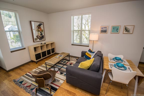 Apartments in Portland, OR - Living Room With Stylish Decor, Hardwood Flooring, and Access to Outdoor Patio