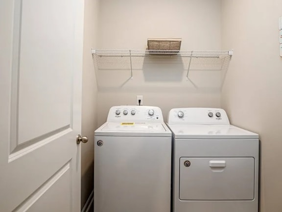A small laundry room with a washer and dryer.