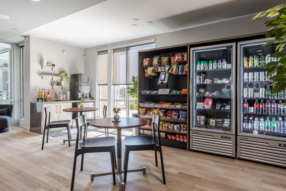 a dining room with a table and chairs in front of a beverage refrigerator
