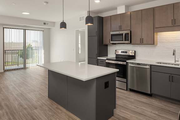 A modern kitchen with a large island in the middle.