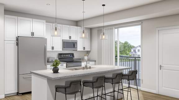 A modern kitchen with a refrigerator, microwave, and bar stools.