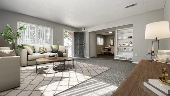 A living room with a couch, a coffee table, and a lamp.