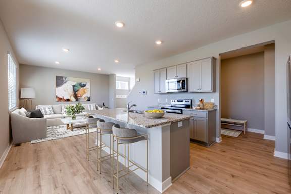 A modern kitchen with a bar area and a dining table.