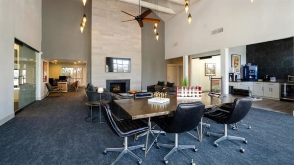 a large room with a table and chairs and a fireplace