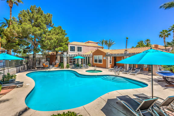 Madison at Black Mountain apartments in Henderson, NV 89015 photo of a resort style pool with lounge chairs and umbrellas