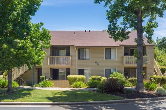 Studio Apartments in Pleasant Hill CA - Brookside - Beige Two Story Apartment Building with Patios and Balconies Surrounded By Lush Landscaping