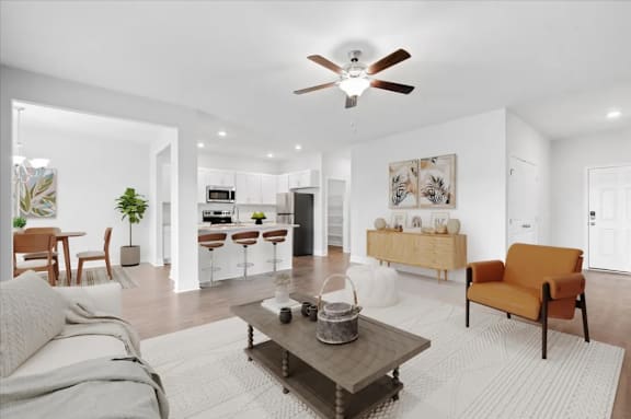 A modern living room with a grey sofa, a coffee table, and a ceiling fan.