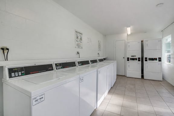 A row of washing machines in a laundromat.