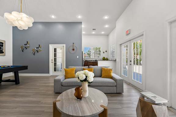 Kissimmee, FL Townhomes for Rent - Estates at Lake Cecile –A modern living room with a grey couch and a coffee table.