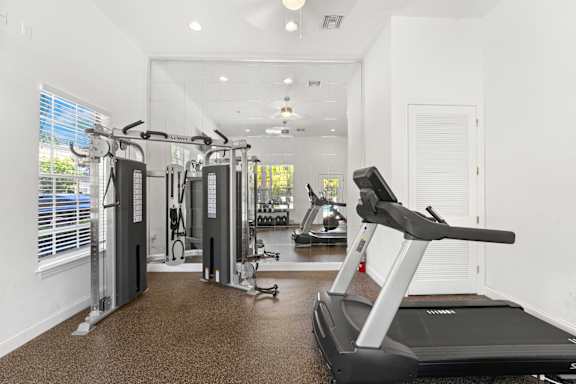 Kissimmee, FL Townhomes for Rent - Estates at Lake Cecile –A spacious gym with treadmills, elliptical machines, and other exercise equipment.