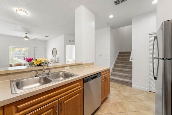 Kissimmee, FL Townhomes for Rent - Estates at Lake Cecile –A kitchen with a sink, stove, and refrigerator.