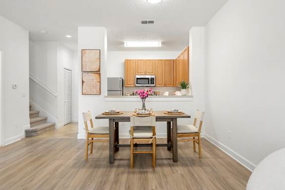 Kissimmee, FL Townhomes for Rent - Estates at Lake Cecile –A dining room with a wooden table and chairs.