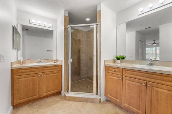 Kissimmee, FL Townhomes for Rent - Estates at Lake Cecile –A bathroom with a walk-in shower and double sinks.