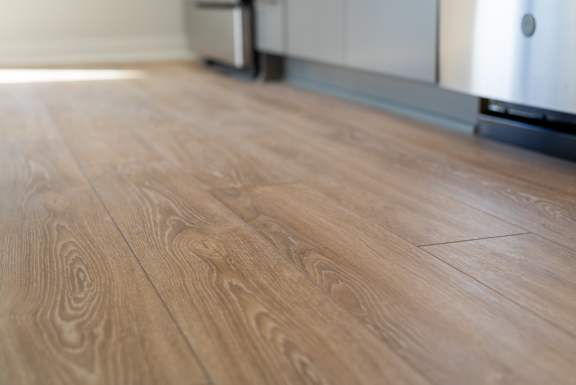 A close up of a wooden floor with a blurred background.