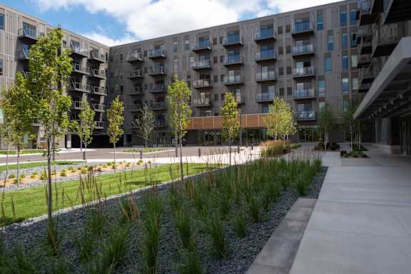 A modern building with a concrete walkway in front.