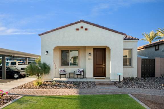 A house with a brown door and a small front yard.