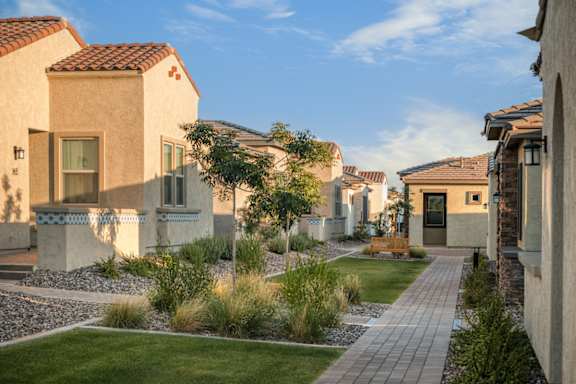 A row of houses with a pathway between them.