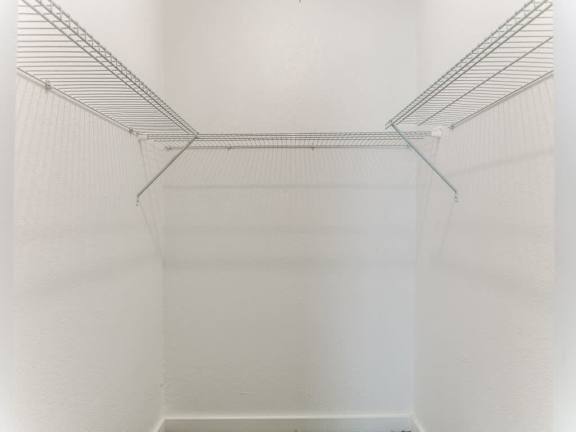 Empty white shelving unit in a room.
