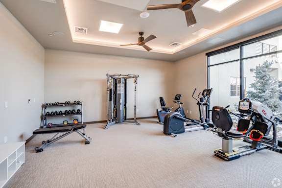 A spacious home gym with a variety of exercise equipment.