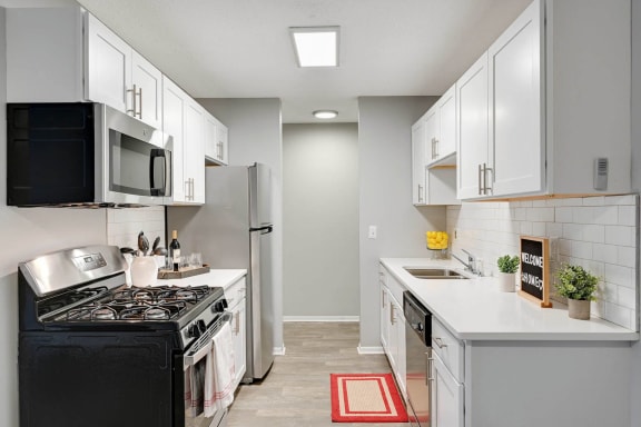 Stratford Wood Apartments and Townhomes in Minnetonka, MN photo of a kitchen with white cabinets and a stove and a refrigerator