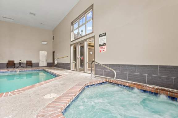 A hot tub in a room with a glass door at MonteVista Apartments, Beaverton, Oregon