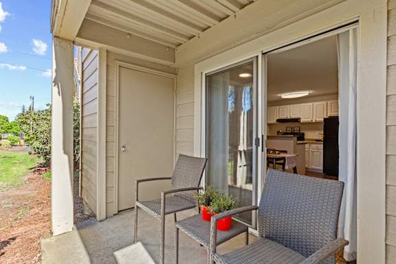 A patio with a chair and table is shown.