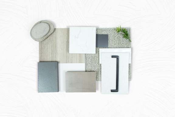A collection of modern, minimalist furniture pieces are displayed on a white background.