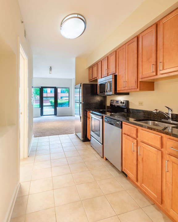 a kitchen with wooden cabinets and a sink and a refrigerator