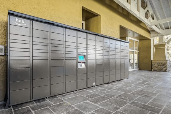 A row of Hub branded lockers are lined up on a stone floor.